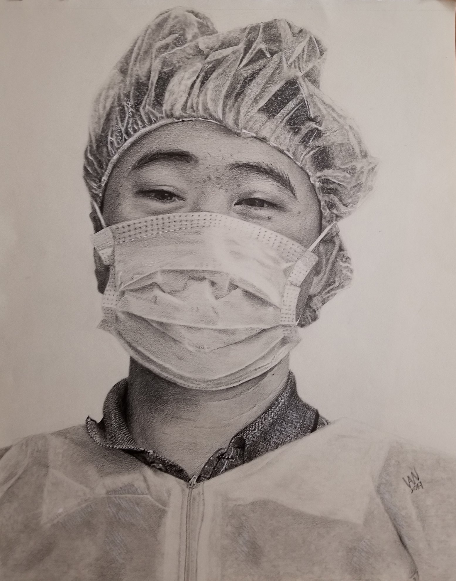 Graphite drawing of a man wearing scrubs and a face mask.